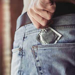 man getting a condom out of his pocket