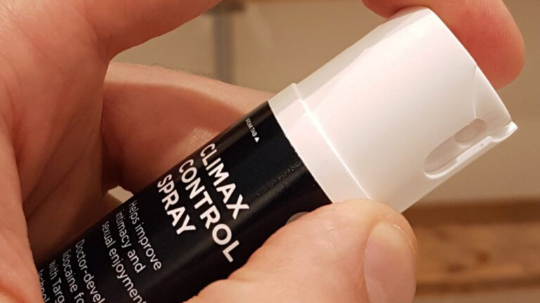 A hand holding a delay spray