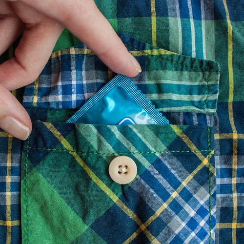 image of a man in pajamas with a condom