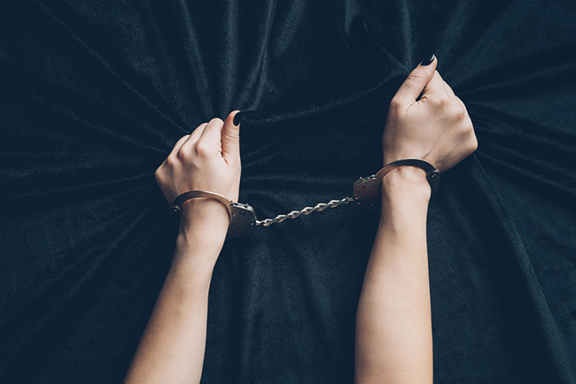 photo of a woman wearing sexy handcuffs