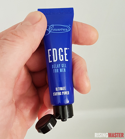 photo of a hand holding a tube of edge delay gel