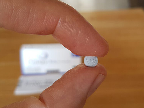 me holding 30mg priligy pill