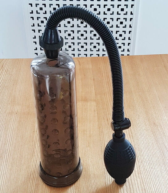 photo of a penis pump standing upright on a table